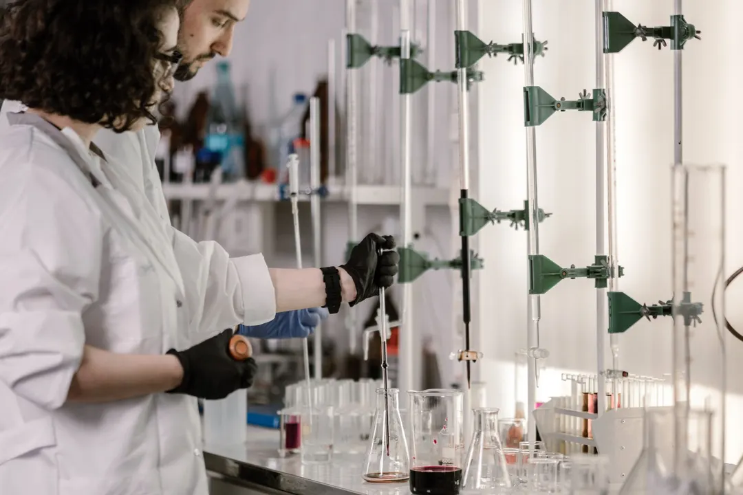 Two researchers at a bench, as shot