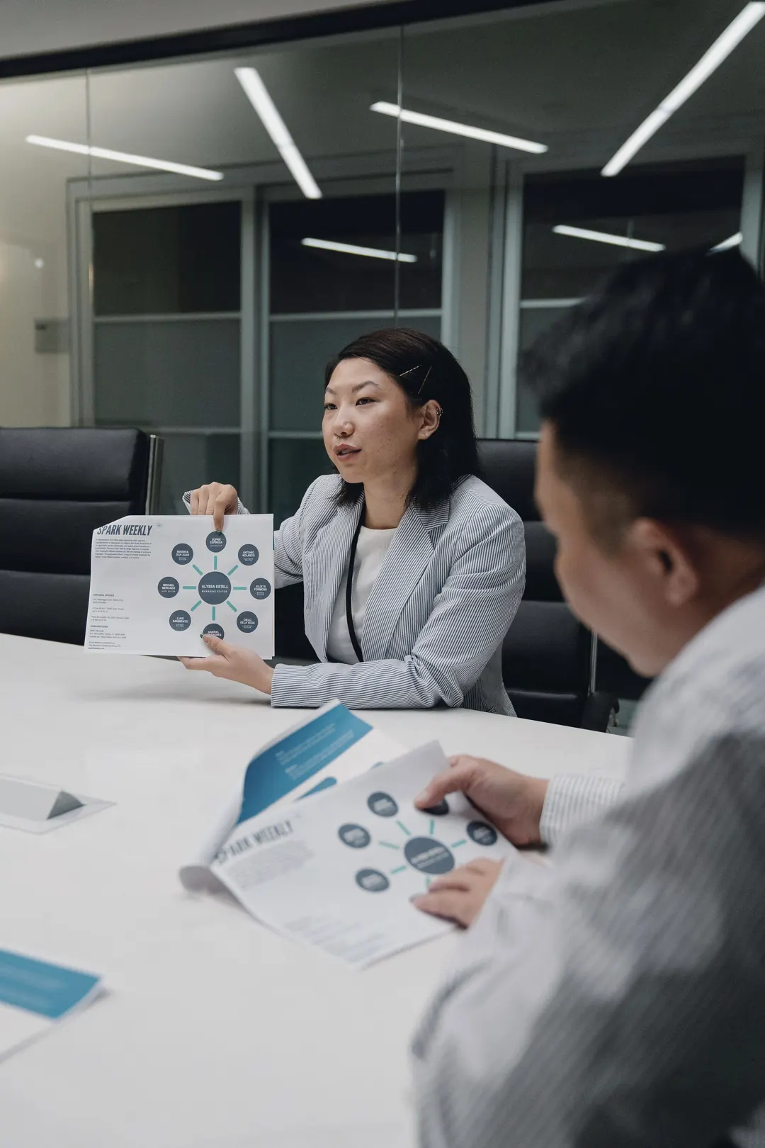 A founder walks an investor through a printed deck.