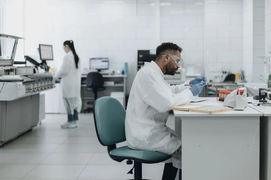 A researcher at work in a long, open laboratory.